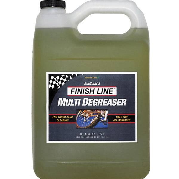 Finish Line EcoTech 2 biodegradable bike degreaser in a workshop setting, showing the eco-friendly cleaner bottle with labels.