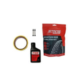 Stan's No Tubes mountain bike tubeless kit with sealant and valves for MTB rims, ready for tubeless setup and repairs.