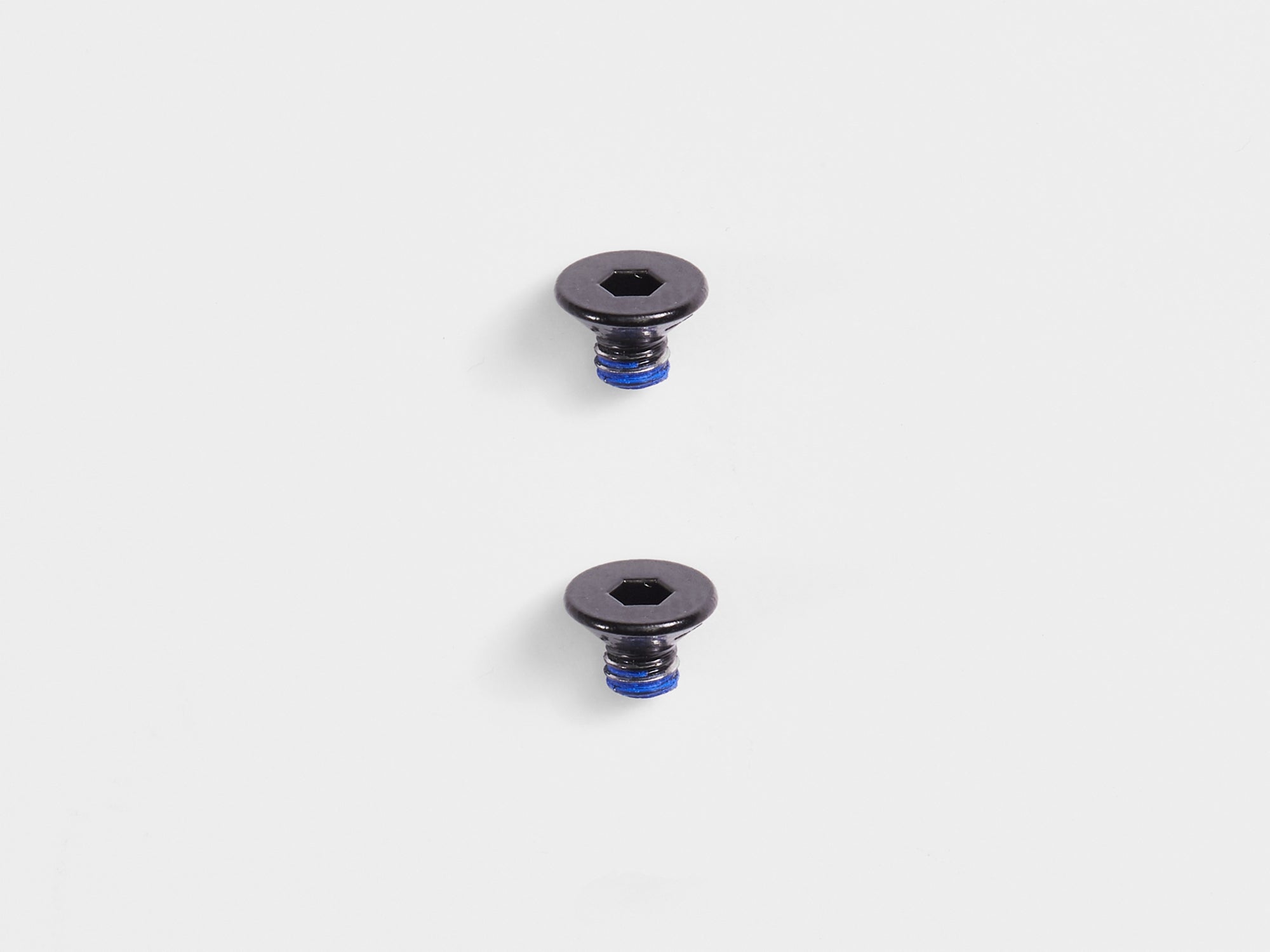 Pair of black Bontrager Pro Blendr Adapter Puck Bolts M3 x 4mm for computer mount accessories, shown in close-up.