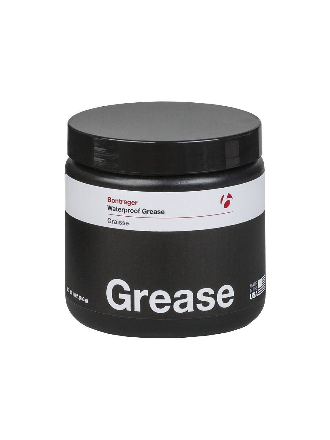 Bontrager bicycle grease lubricant for waterproof, low friction, compatible with carbon fiber bikes, shown in workshop setting