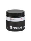 Bontrager bicycle grease lubricant for waterproof, low friction, compatible with carbon fiber bikes, shown in workshop setting