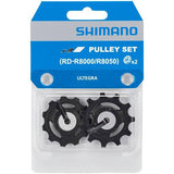 Shimano Ultegra RD-R8000 and RX812 GRX rear derailleur pulley set for bike component replacement.