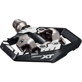 Shimano Deore XT PD-M8120 trail wide SPD pedals for off-road mountain biking, featuring durable metal bodies and adjustable tension.