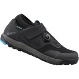 Shimano GE9 gravel shoes with BOA Fit System and SPD cleat compatibility, shown in black with textured fabric and secure closure.