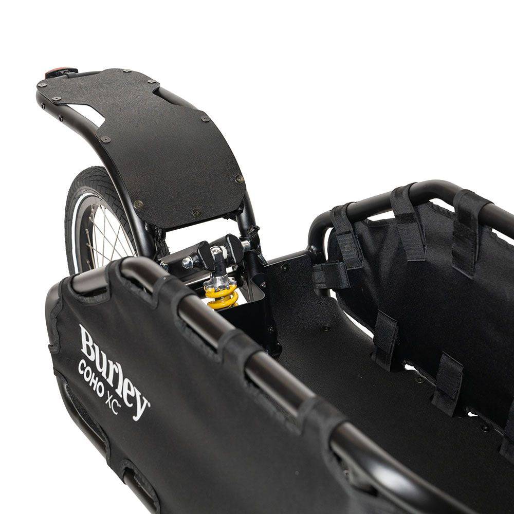 Burley Coho XC cargo bike trailer with suspension and quick release lever, showing its durable construction and loading area.