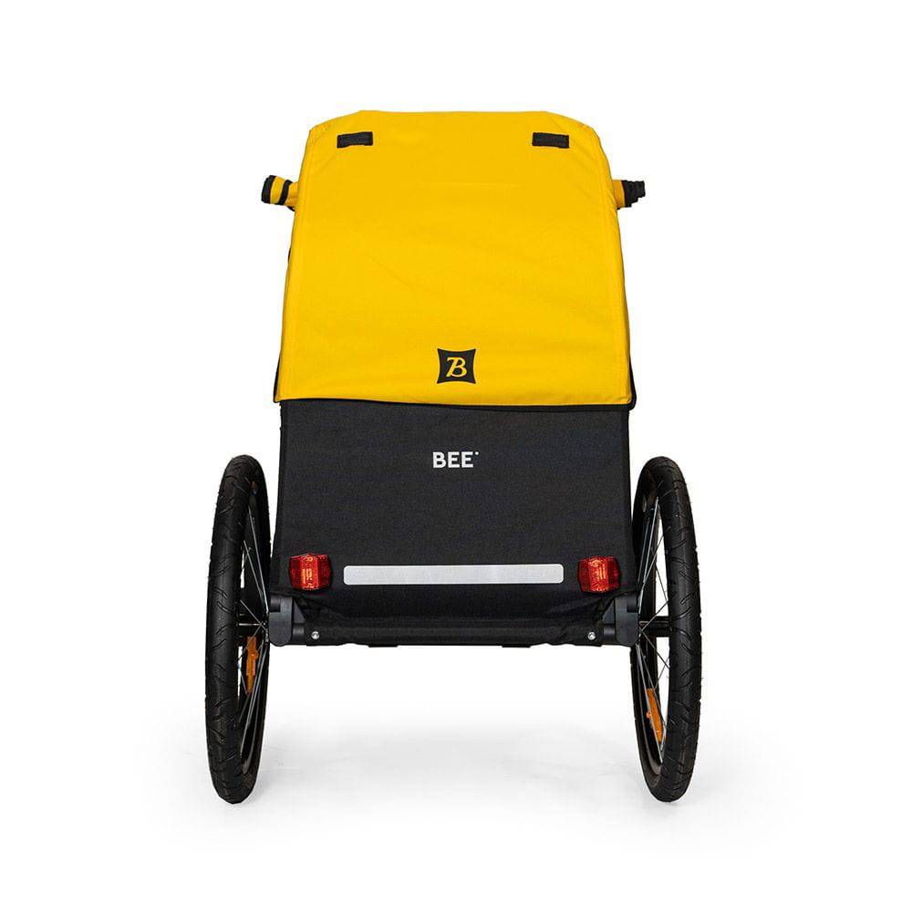 Burley Bee bike trailer for single child with safety harness and weather cover, outdoor accessory for secure cycling with kids.