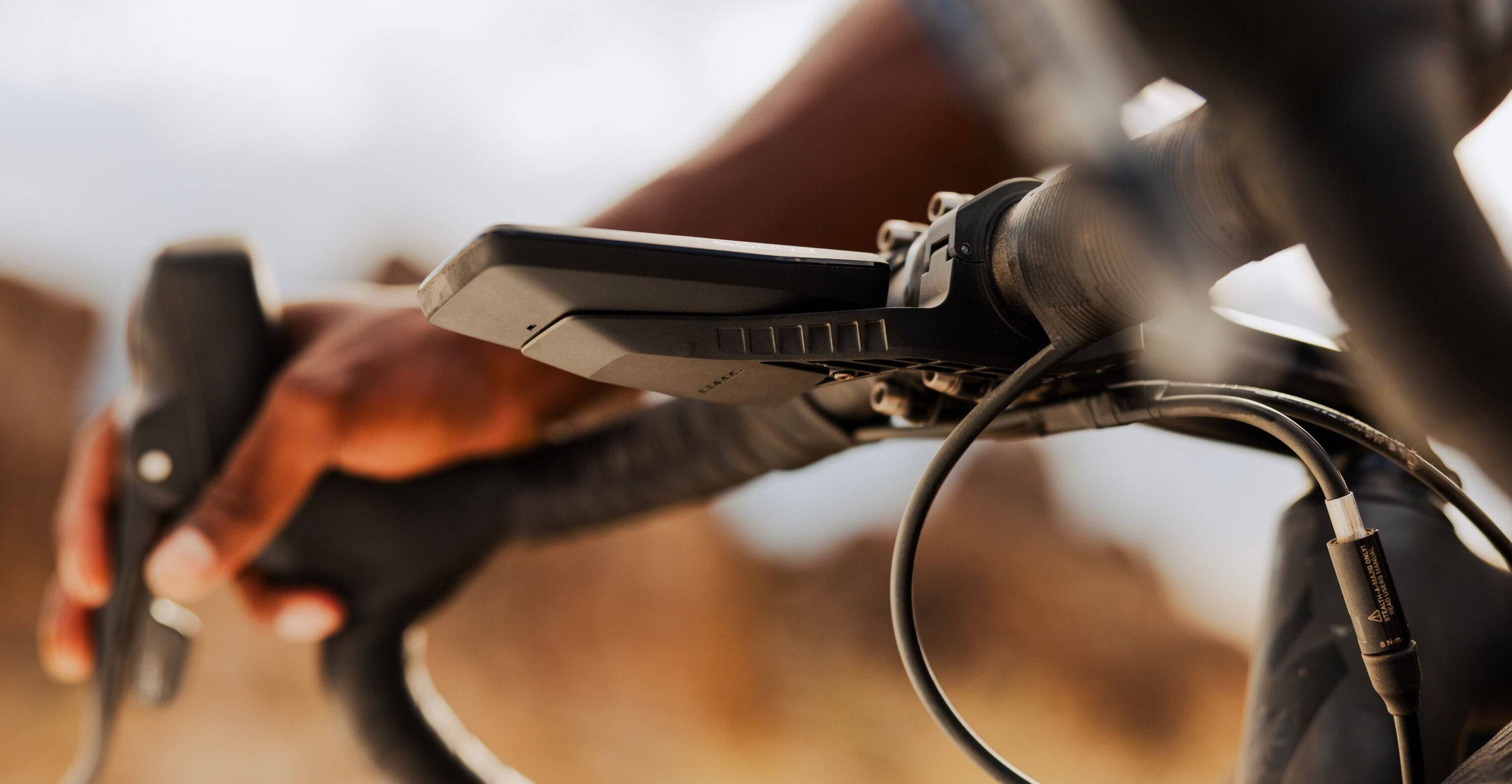 Coros DURA Solar GPS Bike Computer with 120-hour battery, dual-frequency GPS, and navigation features, shown on a bike handlebar.