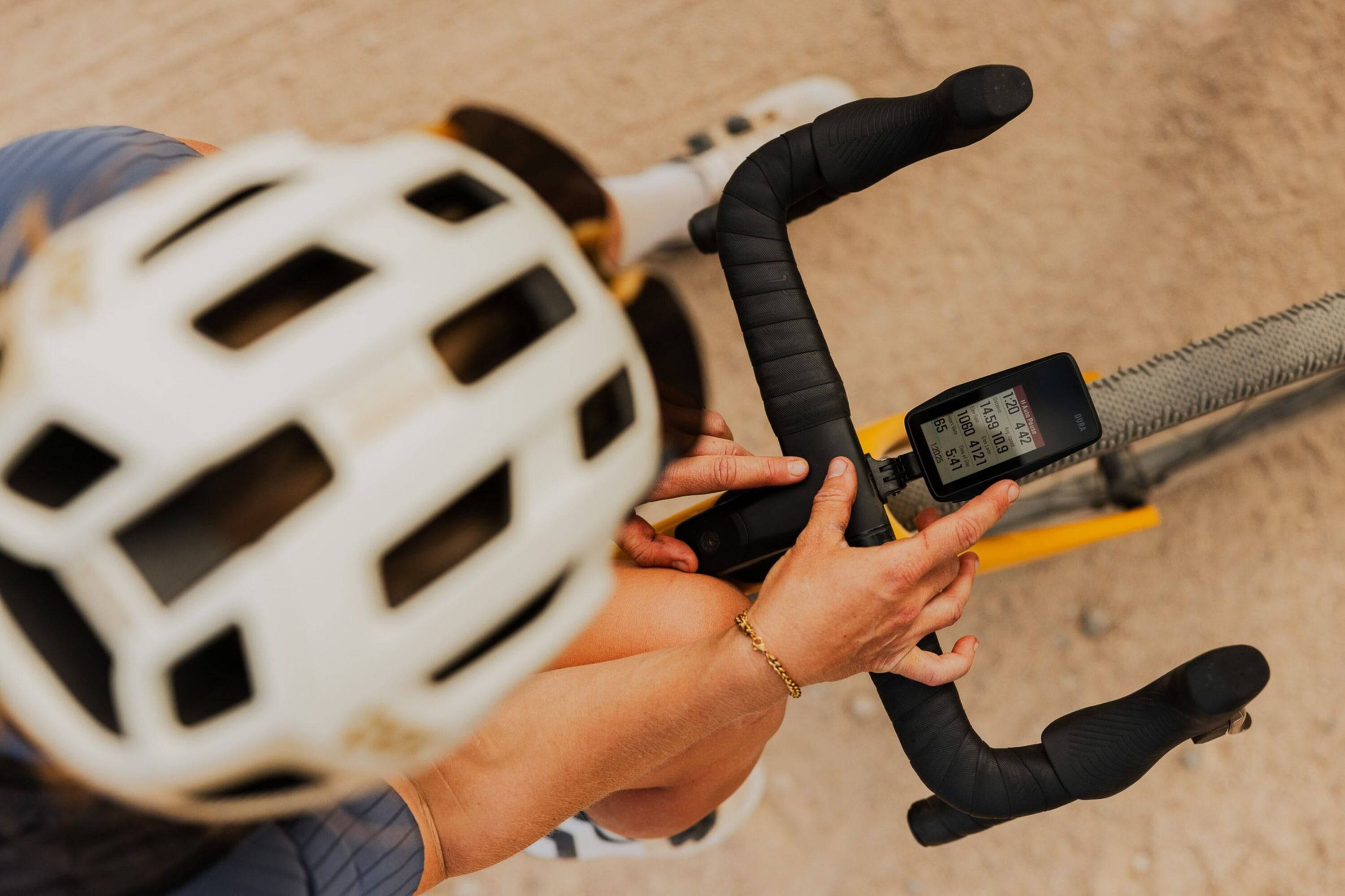 Coros DURA Solar GPS bike computer with dual-frequency GPS and navigation, showing a screen with ride data and battery status