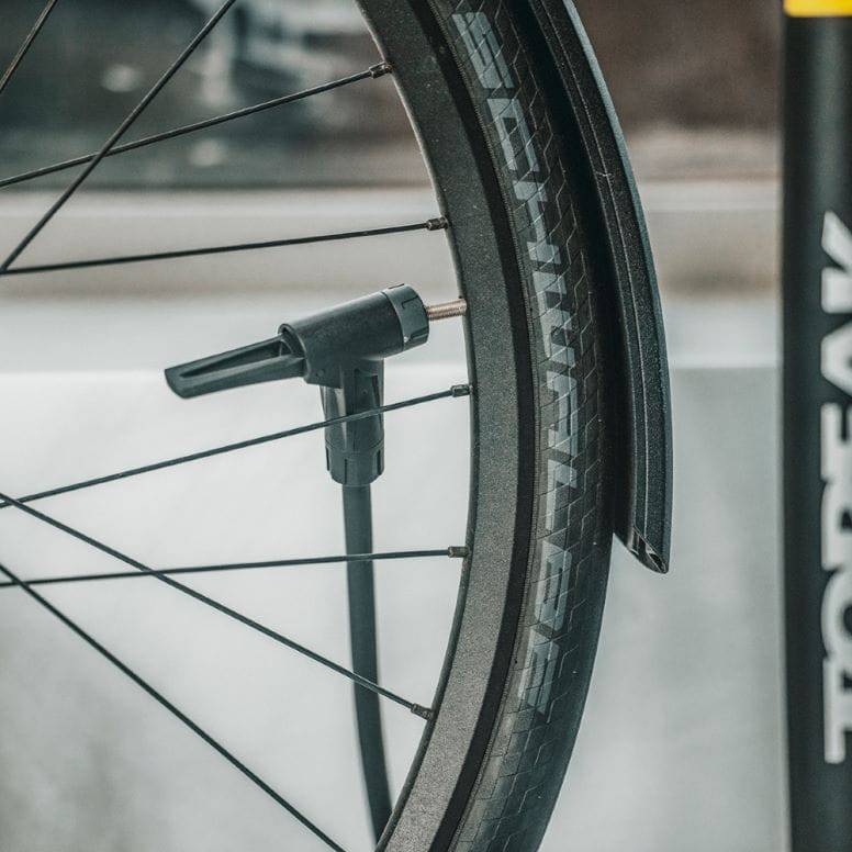 Yellow Topeak JoeBlow Sport EX floor pump with SmartHead for Presta and Schrader valves, featuring digital gauge and ergonomic handle.
