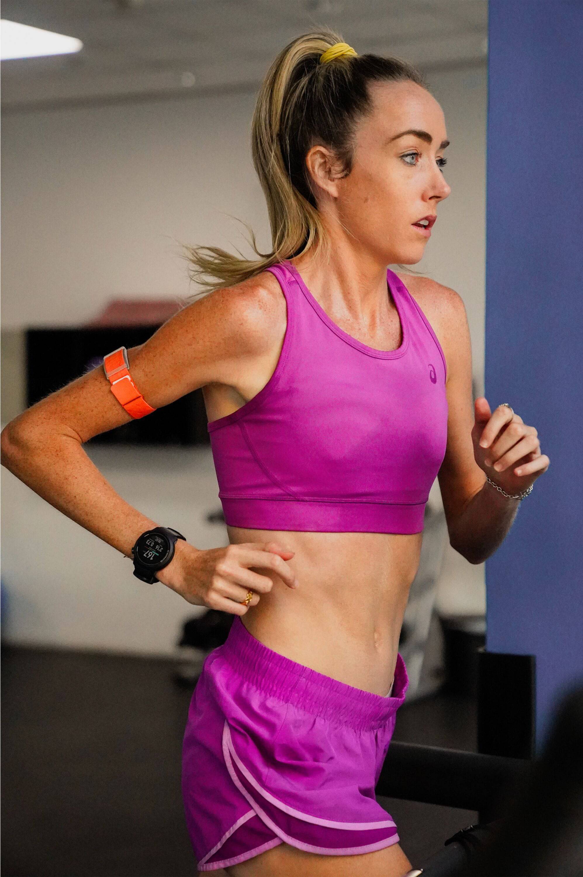 Coros Heart Rate Monitor arm band with Bluetooth, showing a fitness tracker worn on a person's arm during a run.