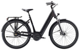 Trek District+ 4 Coaster Lowstep electric hybrid bike for women with Bosch motor, featuring a sleek frame and comfortable saddle.