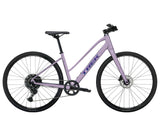 Trek FX 1 Midstep Gen 4 hybrid bike with comfortable frame, suitable for urban and trail commuting, shown in a city setting