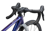 Liv Seek 2 MY26 youth gravel bike with hydraulic disc brakes and adjustable seatpost, shown with black frame and knobby tires.