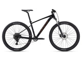 Giant Talon 2 2024 mountain bike with Shimano CUES U4000 drivetrain and disc brakes, shown outdoors on trail.