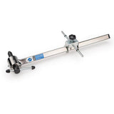 Park Tool DAG-2.2 derailleur hanger alignment gauge for precise bike adjustments, shown in a workshop setting.