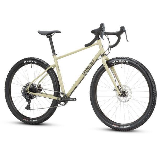Genesis Vagabond 10 gravel bike with disc brakes, unisex touring bicycle shown on a trail, durable and versatile for gravel riding.