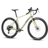Genesis Vagabond 10 gravel bike with disc brakes, unisex touring bicycle shown on a trail, durable and versatile for gravel riding.