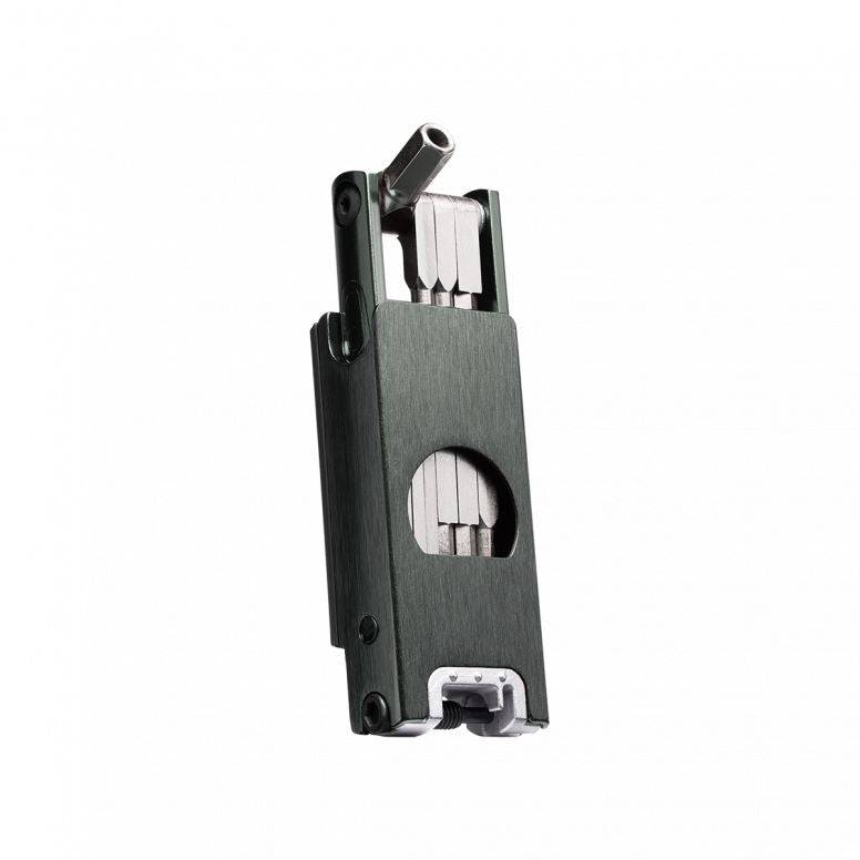 Crankbrothers F16 Black multi-tool with 16 functions for tubeless bike repairs, shown in a workshop setting.