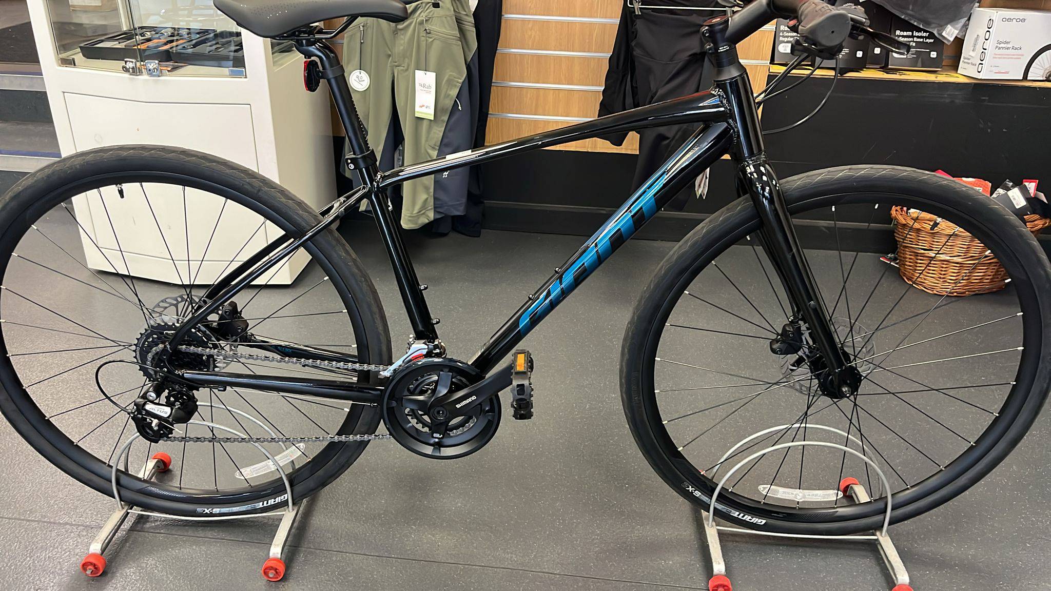 Giant Escape Disc 2 hybrid bike with Shimano Altus gears and disc brakes, 2025 model, view of frame and front wheel.