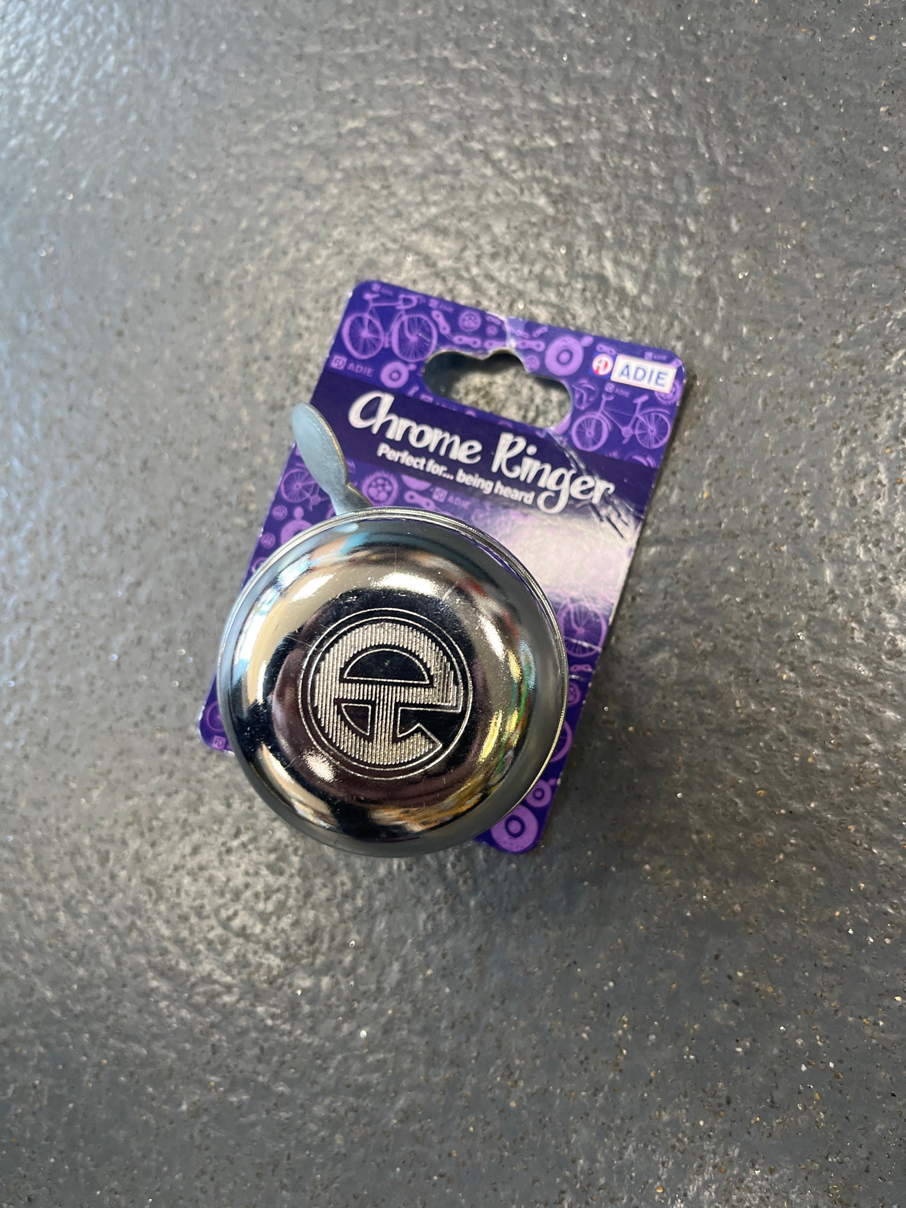 Adie Bells Classic Chrome Bike Bell mounted on a bicycle handlebar, showcasing its stylish and durable design.