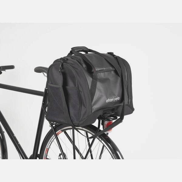Black AtranVelo PULSE AVS 36L duffle bag with AVS mounting system, showing the rugged exterior and adjustable straps.