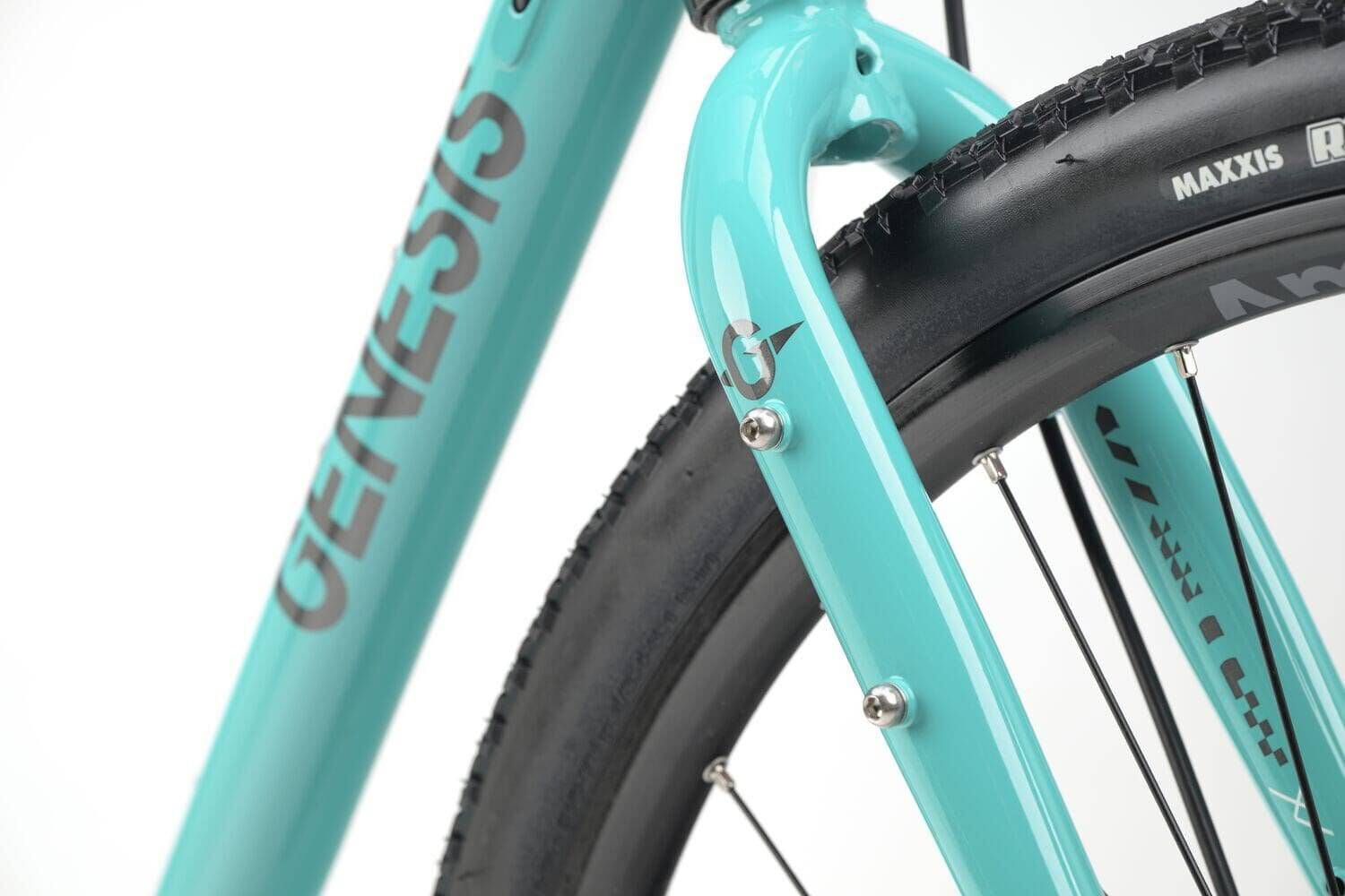 Genesis CDA 20 gravel bike with drop bars, 700c wheels, designed for mixed terrain and commuting, showcasing its durable frame.