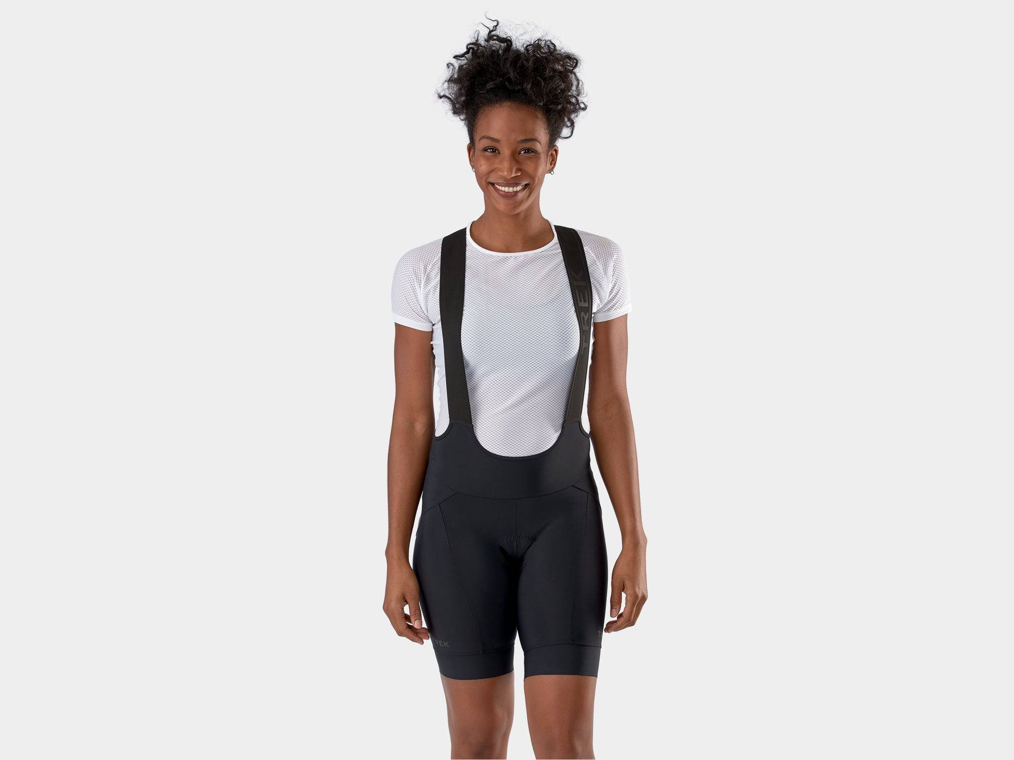 Trek Circuit Women's Eco-Friendly Cycling Bib Shorts showing fitted black shorts with padded chamois for all-day comfort.