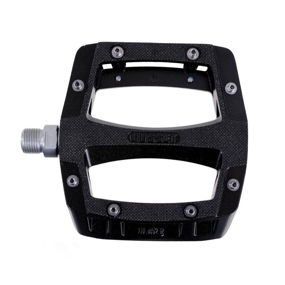 Gusset Components Slim Jim flat pedal with replaceable pins and Cr-Mo axle, showing the pedal's sleek design and textured surface.