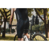 Black Topeak Tri Cage 2 bike water bottle cage attached to saddle carrier, lightweight and durable cycling accessory.