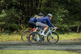 Madison men's windproof packable cycling jacket with ventilation technology, shown folded and partially worn, ideal for outdoor riding.