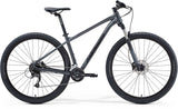 Merida Big Nine 60 mountain bike featuring Shimano Altus gears and internal cable routing, black frame with knobby tires.