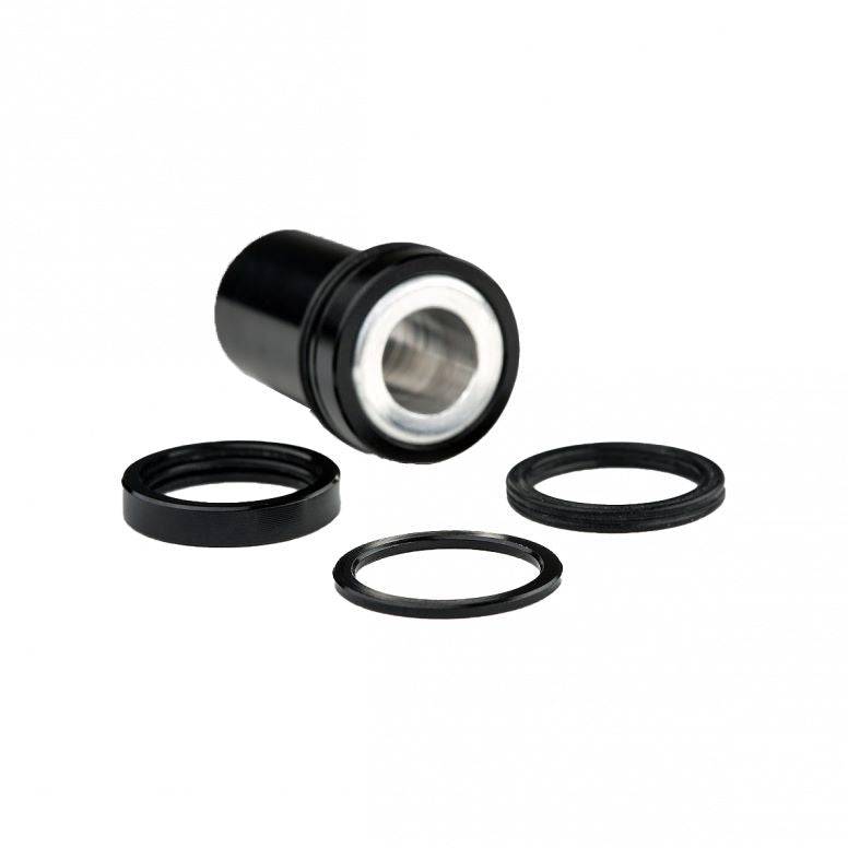 Cane Creek Double Barrel rear shock mounting hardware and spare accessories, including bolts and bushings for bike suspension.