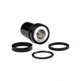 Cane Creek Double Barrel rear shock mounting hardware and spare accessories, including bolts and bushings for bike suspension.