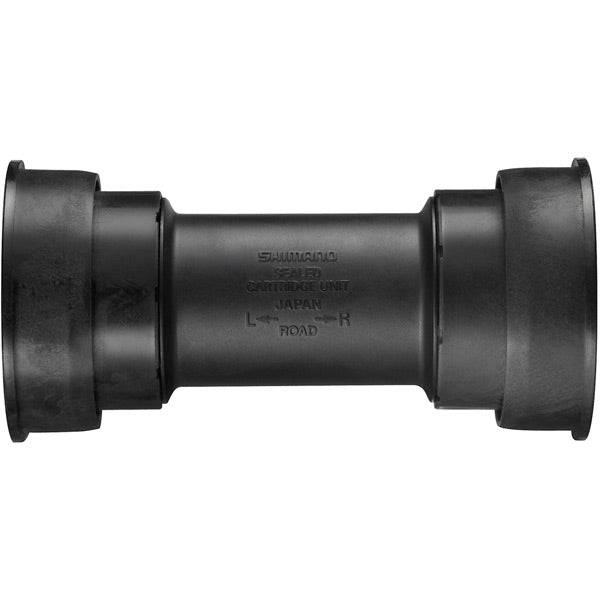 Shimano Road Press Fit Bottom Bracket with Inner Cover for 86.5mm shell, showing the component and cover in a close-up image.