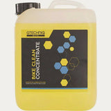 Gtechniq Bike Clean Concentrate eco-friendly bike cleaner in a workshop setting with bottle and cleaning tools.