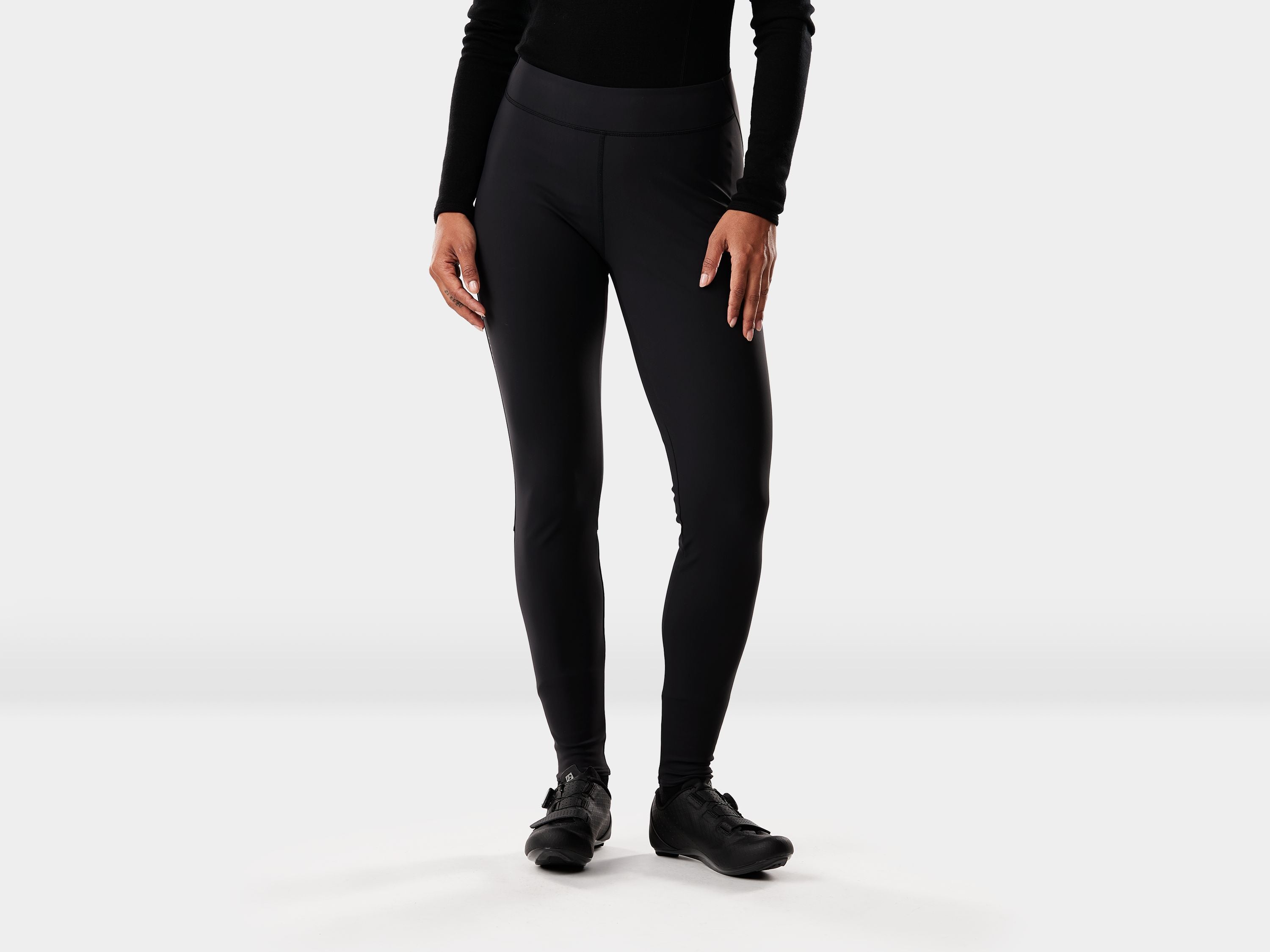 Black Trek Circuit Women's thermal cycling tights, fitted and secure, designed for warmth and comfort during outdoor rides.