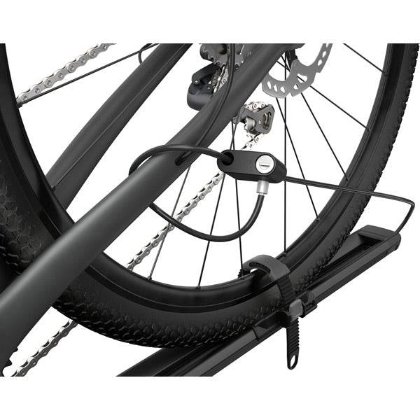 Thule 564 FastRide fork mount bike carrier with lock, designed for quick release front forks, shown attached to a vehicle roof rack.