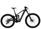 Trek Slash+ 9.7 mountain bike featuring high-pivot suspension, designed for aggressive trail riding, shown on rugged terrain.