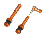 Granite Match Presta valve stem with orange Juicy Nipple Cap and valve core remover, bicycle component for tire inflation.