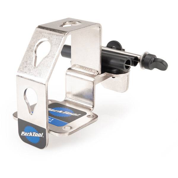 Park Tool WH-1 multi-position wheel holder for thru-axle and quick-release wheels, used in workshop for bike maintenance.
