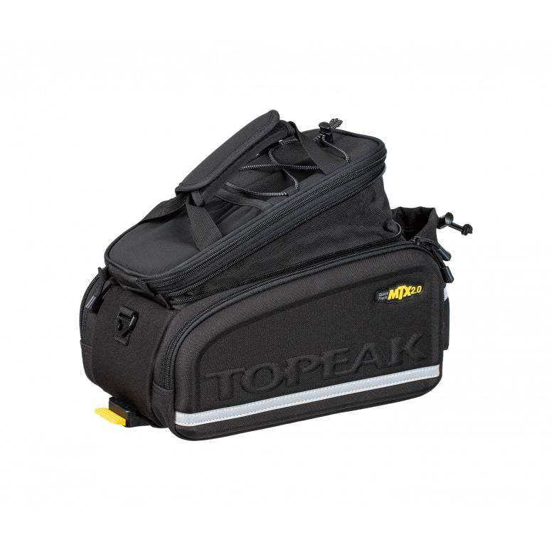 Topeak MTX TrunkBag DX 2.0 black bike rack bag with multiple compartments and reflective safety features, mounted on a bike.