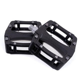 Gusset Components Slim Jim flat pedal with replaceable pins and Cr-Mo axle, showing durable metal construction and textured pedal surface.