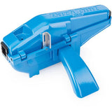 Park Tool CM-25 professional bike chain scrubber with replaceable brush and sponge cartridge, used in workshop for cleaning bike chains.