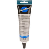 Park Tool HPG-1 high performance bicycle grease for bearings and components, shown in a workshop setting.