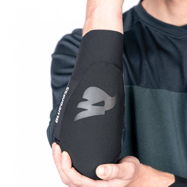 Bluegrass Aura Core Level 1 mountain bike elbow pads with triple-flex SAS-TEC protection, blue color, and adjustable straps.