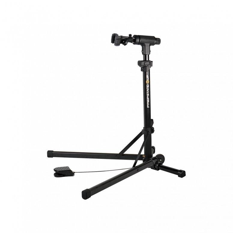 Topeak PrepStand EUP Pro foldable bike workstand in black for e-bikes and heavyweight bikes, shown in workshop setting