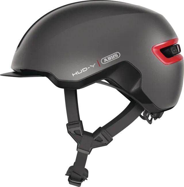 ABUS HUD-Y urban cycling helmet with rechargeable rear LED light, designed for city bike riders, featuring a sleek, protective helmet design.