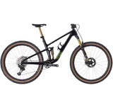 Trek Top Fuel 9.9 XTR Di2 mountain bike with electronic shifting and adjustable suspension, shown in a rugged outdoor setting.
