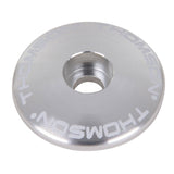 Silver Thomson 1 1/8 bike stem cap, a spare component for bike stems and seatposts, designed for secure fitting and style.