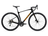 Giant Revolt Advanced 3 2024 gravel bike with Shimano GRX 400 groupset and disc brakes, featuring a sleek frame and knobby tires.